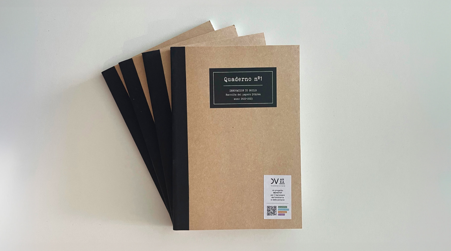 Set of four brown notebooks titled "Quaderno No. 1 – Innovation to Build", a collection of DVArea papers from the years 2022–2023. The cover features the DVArea logo and a QR code, highlighting the company’s commitment to environmental sustainability and social impact.