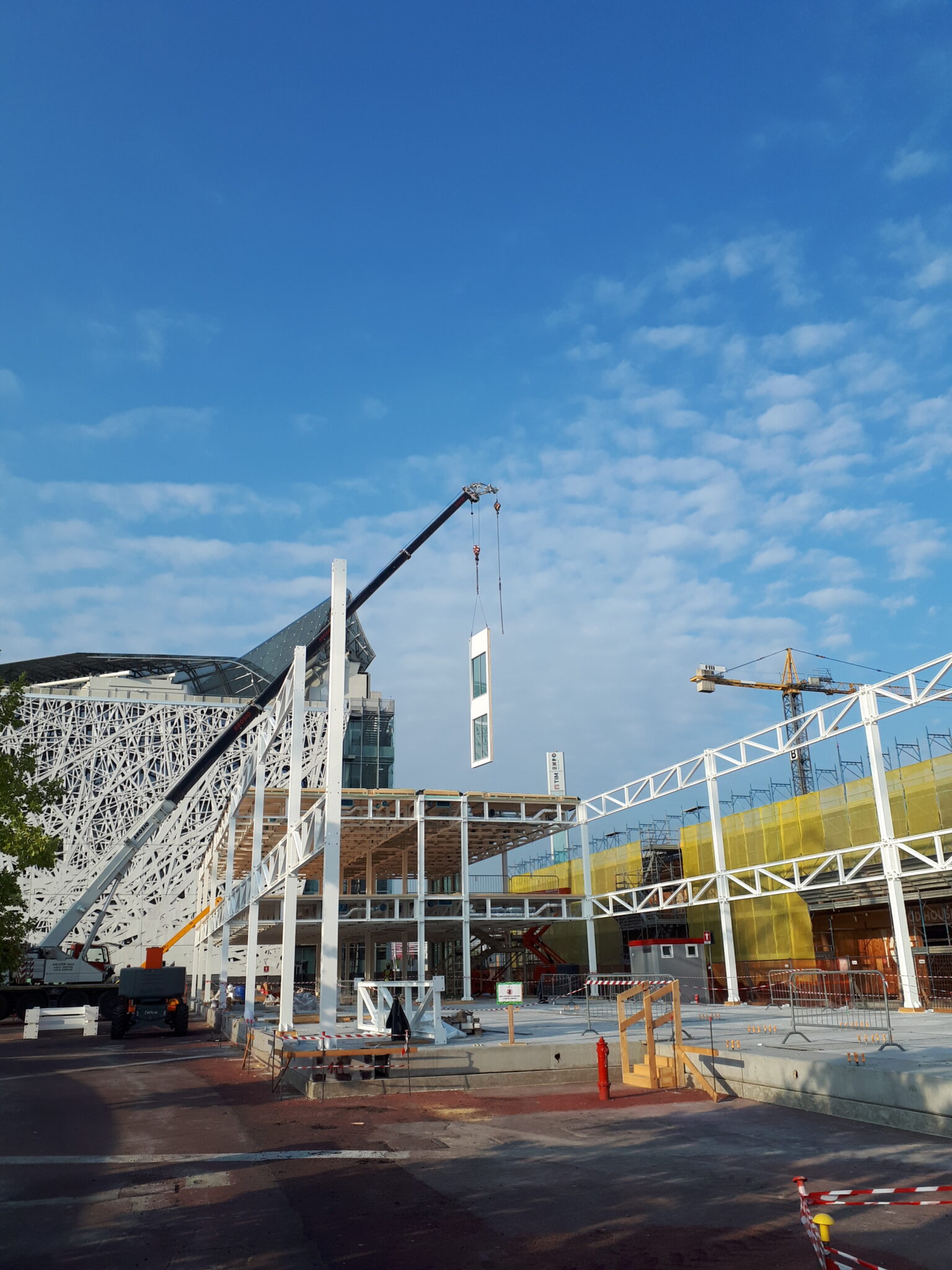 MIND Area, Milan. The image shows a view of the site with the metal structures already being assembled and the partially completed building in the background.