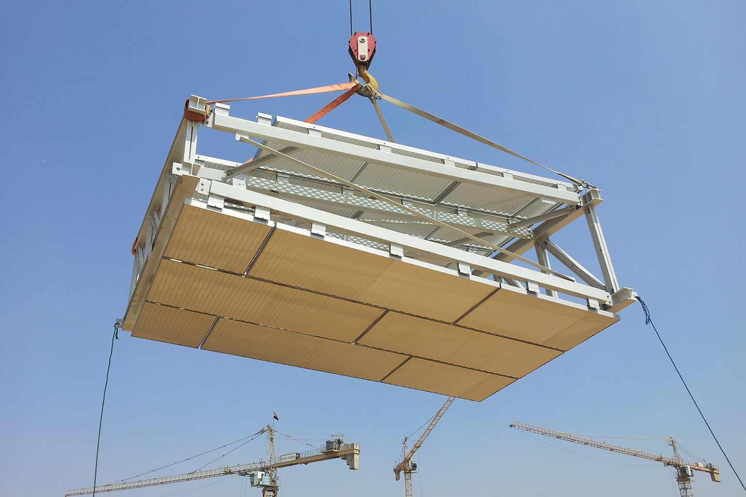 Il Cairo, Egypt. Lifting of a prefabricated module of the GEM project by construction crane, featuring a metal structure and a bottom cladding in lightweight panels, during elevated assembly operations.